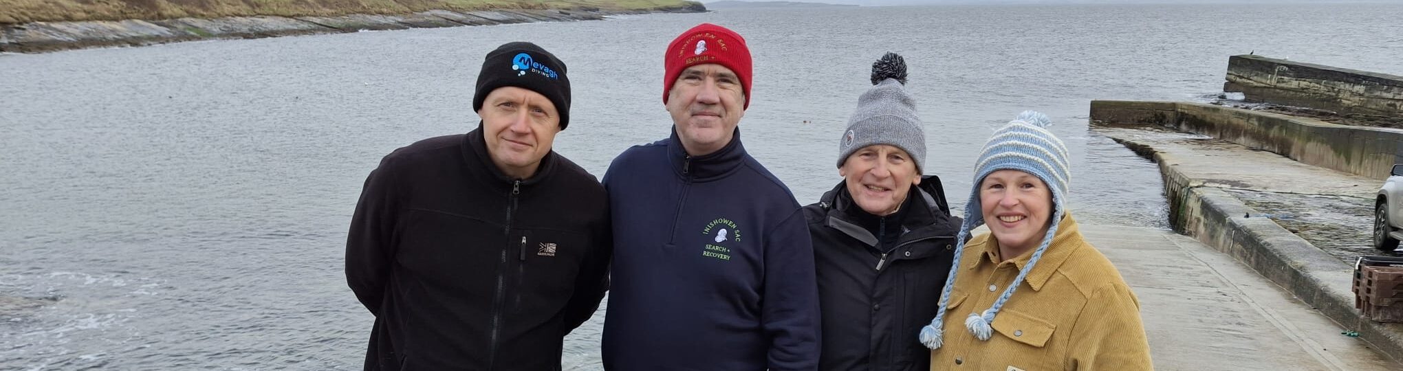 Four members of ISAC pose on a pier in donegal during an Instructor training exercise